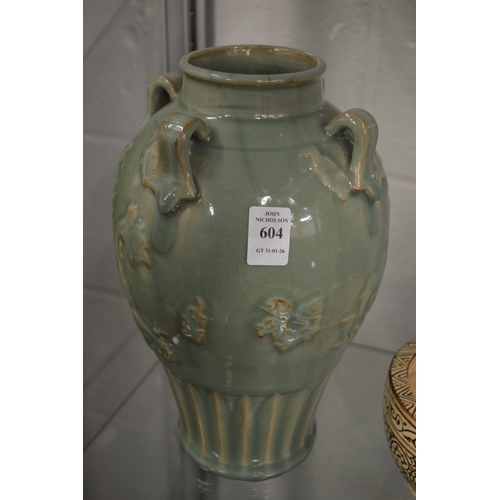 604 - A large Chinese celadon glazed vase with four strap work handles.