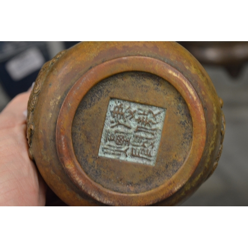 612 - A Chinese bronze censer cast with a dragon.