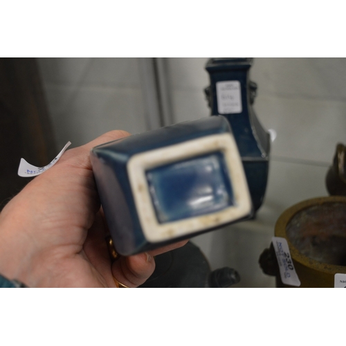 614 - A pair of Chinese blue glazed square shaped vases.