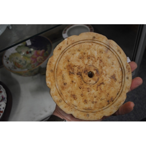 617 - A Chinese carved hard stone circular tablet.