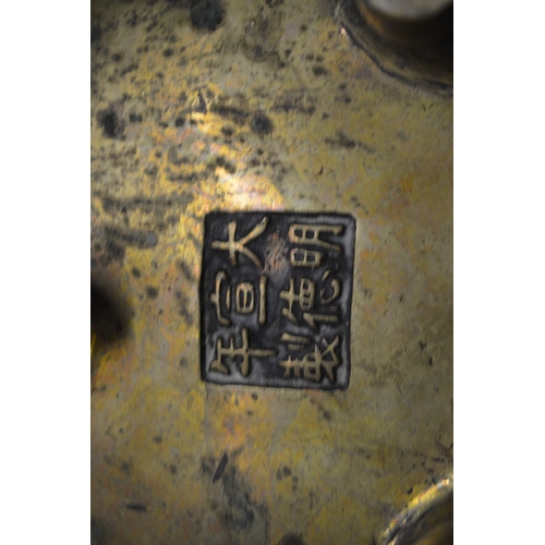 619 - A Chinese bronze twin handled censer with six character mark to the base.