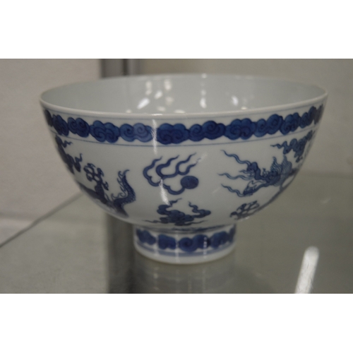 625 - A good Chinese blue and white dragon bowl with four character mark to the base.