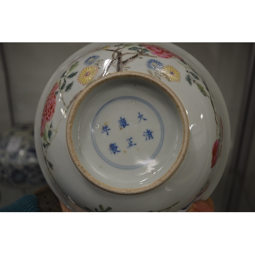 629 - A good Chinese circular bowl painted with flowers, six character mark to the base.