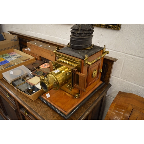 639 - A good Victorian brass and mahogany slide projector, converted to electricity complete with numerous... 
