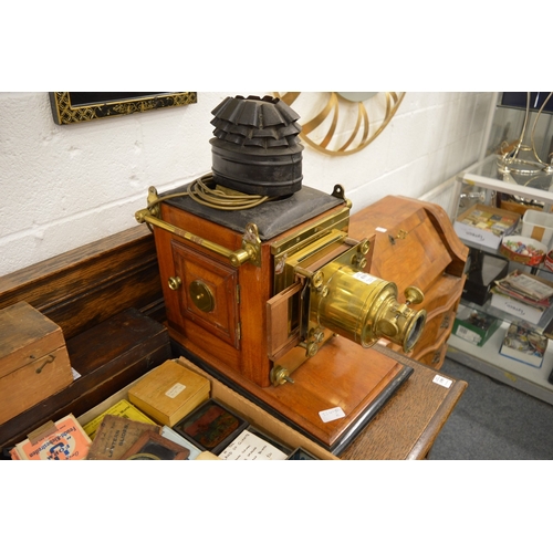 639 - A good Victorian brass and mahogany slide projector, converted to electricity complete with numerous... 