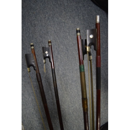 648 - A violin and four various bows.