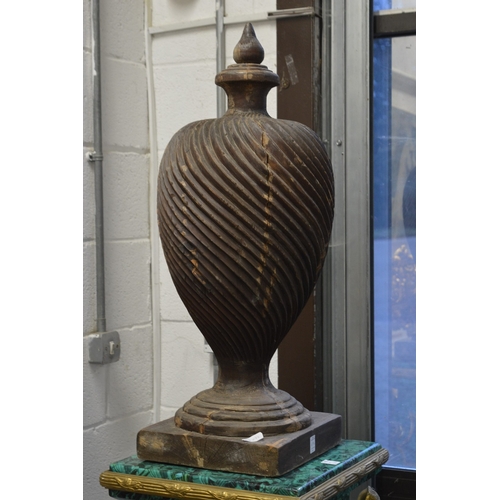 698 - A large pair of turned carved wood urns.