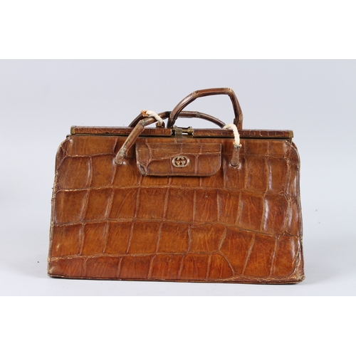 482 - AN EARLY GUCCI CROCODILE SKIN BAG. 13ins long.
