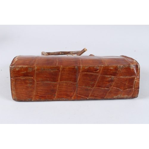 482 - AN EARLY GUCCI CROCODILE SKIN BAG. 13ins long.