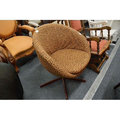 318 - An animal print upholstered swivel tub chair.