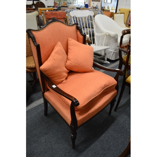 321 - A mahogany framed open armchair with carved decoration.