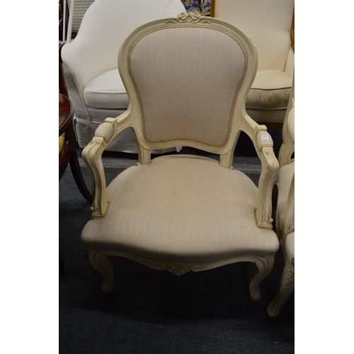325 - A French style cream painted and upholstered open armchair.