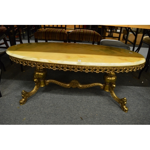 331 - An onyx and brass oval coffee table.