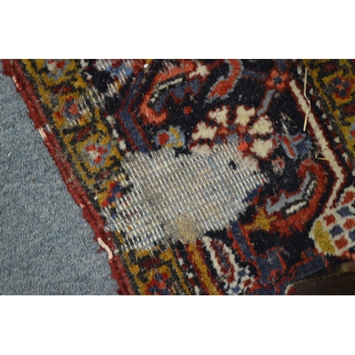 354 - A Persian rug with geometric design (moth damage) 284cm x 192cm.