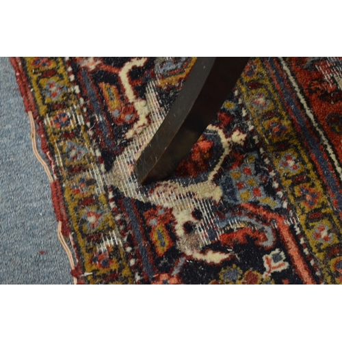 354 - A Persian rug with geometric design (moth damage) 284cm x 192cm.