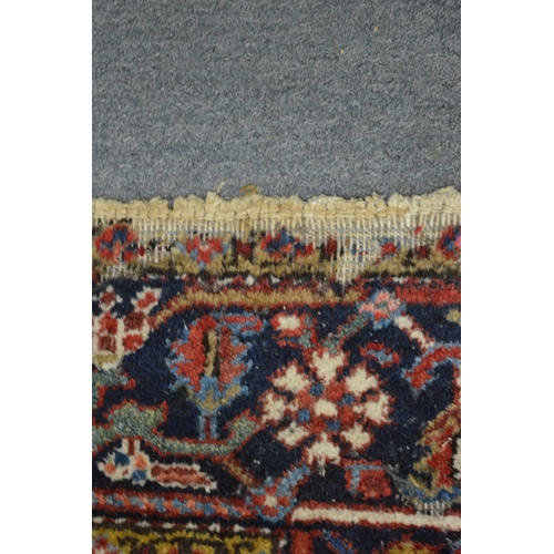 354 - A Persian rug with geometric design (moth damage) 284cm x 192cm.