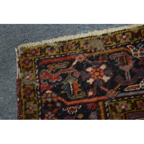 354 - A Persian rug with geometric design (moth damage) 284cm x 192cm.
