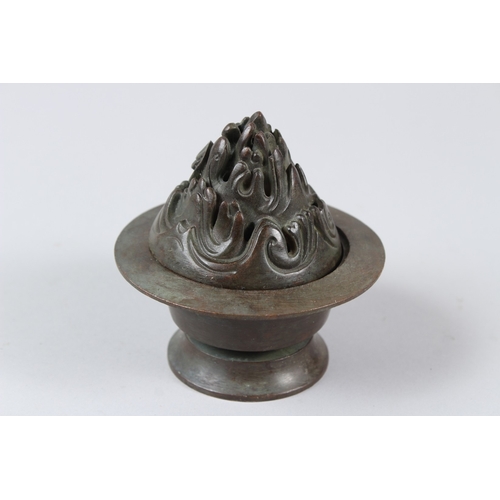12 - A CHINESE BRONZE INCENSE BURNER. 10cms tall.  Under mark to the base.
