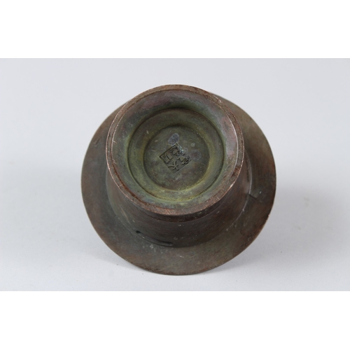 12 - A CHINESE BRONZE INCENSE BURNER. 10cms tall.  Under mark to the base.