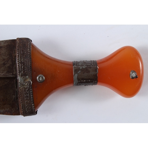 128 - A LARGE 19TH CENTURY ARAB YEMENI JAMBIYA DAGGER with Bakelite handle and silver mounts. 36cms long.... 