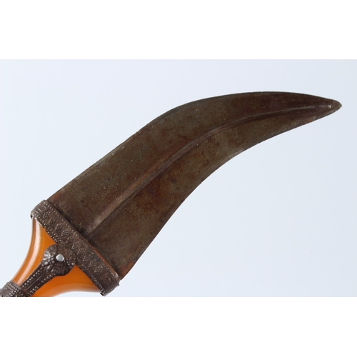 128 - A LARGE 19TH CENTURY ARAB YEMENI JAMBIYA DAGGER with Bakelite handle and silver mounts. 36cms long.... 