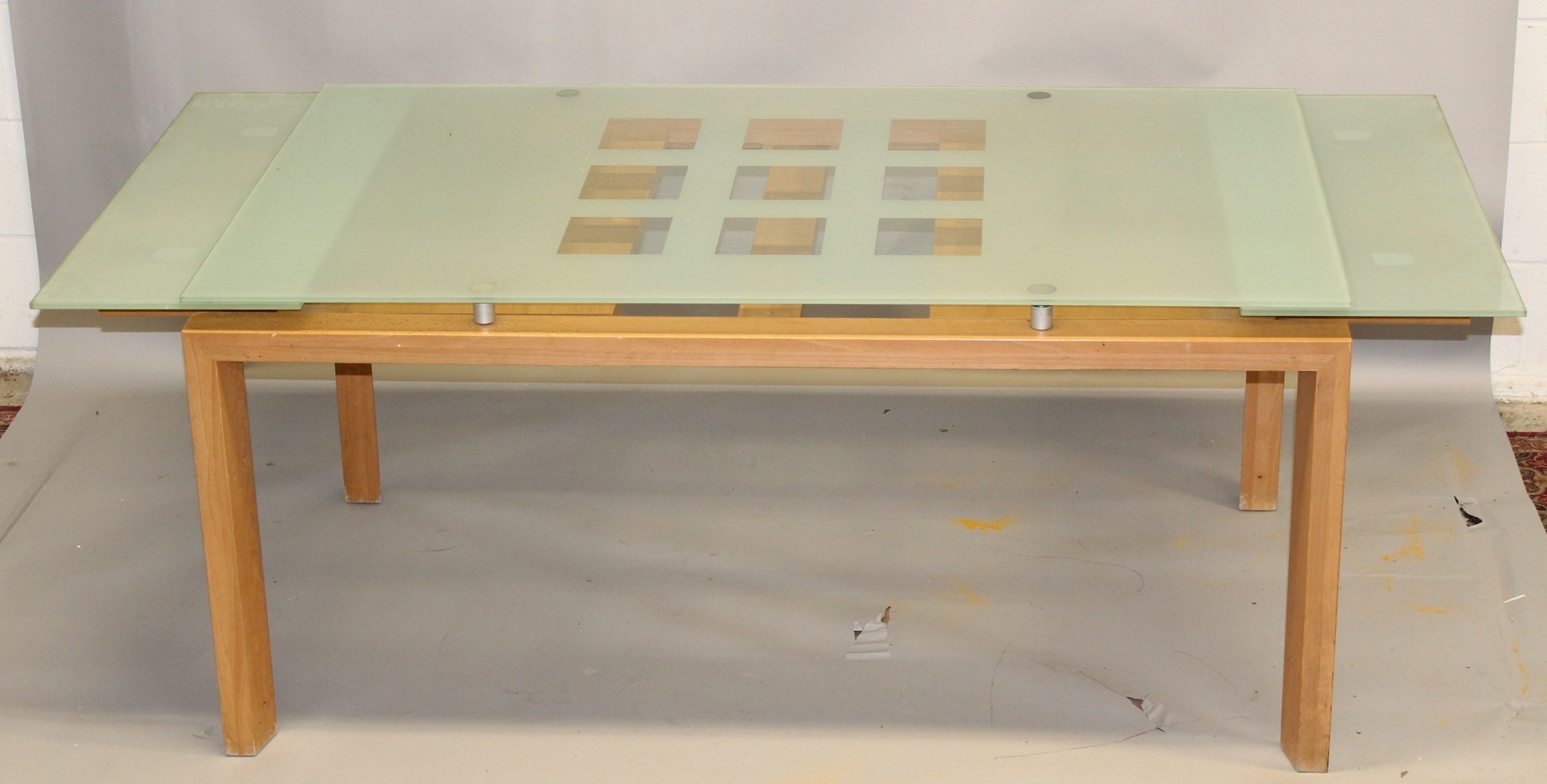 A CONTEMPORARY BEECH FRAMED GLASS TOP EXTENDING DRAW LEAF DINING TABLE ...