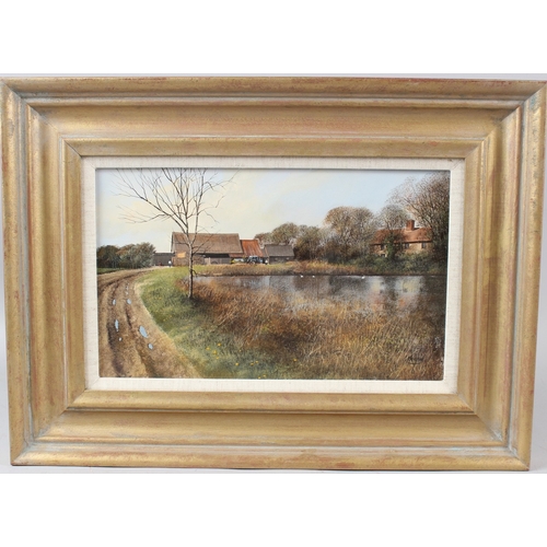 345 - CLIVE MADGWICK (1934-2005)  View of farm and pond  oil on board  signed  19.5 x 32cm