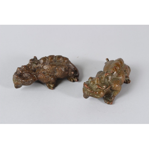 11 - A PAIR OF ORIENTAL BRONZE MYTHICAL BEASTS.  9cms long.