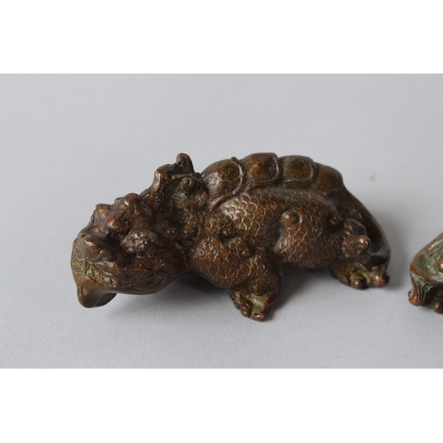 11 - A PAIR OF ORIENTAL BRONZE MYTHICAL BEASTS.  9cms long.