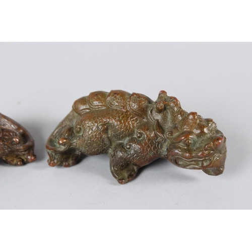 11 - A PAIR OF ORIENTAL BRONZE MYTHICAL BEASTS.  9cms long.
