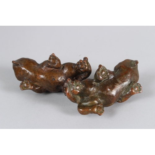 11 - A PAIR OF ORIENTAL BRONZE MYTHICAL BEASTS.  9cms long.