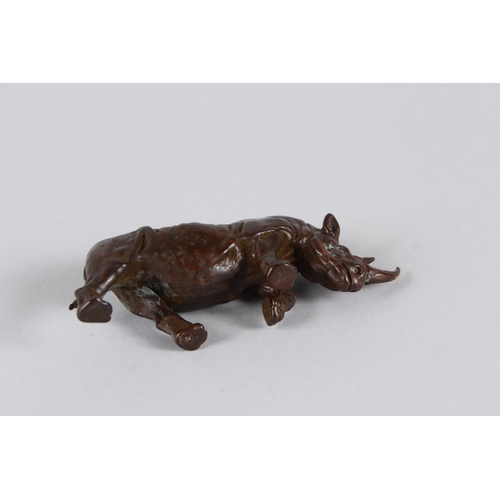20 - A JAPANESE OKIMONO BRONZE RHINOCEROS.  9cms long.
