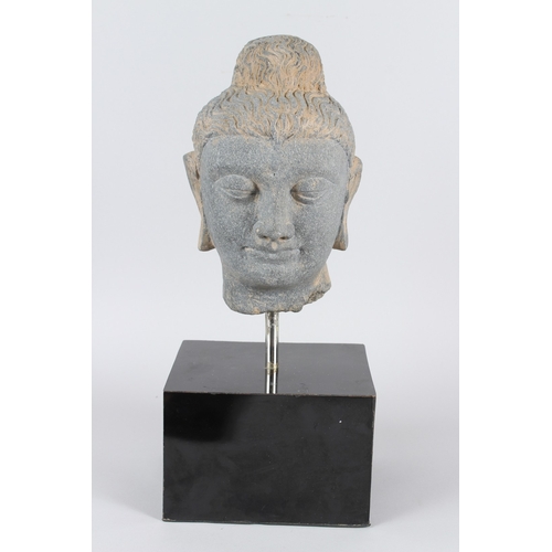32 - A CARVED STONE HEAD OF BUDDHA from the GANDHARA REGION.  20cms high, on a marble base.