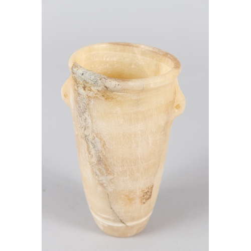 36 - AN EGYPTIAN ALABASTER VESSEL, of tapering cylindrical form, with small lug handles.  14cms high.