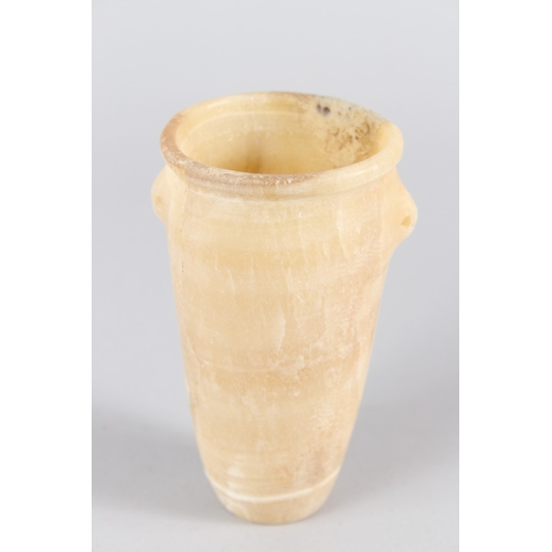 36 - AN EGYPTIAN ALABASTER VESSEL, of tapering cylindrical form, with small lug handles.  14cms high.