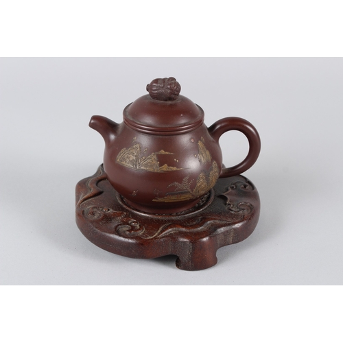 4 - A FINE CHINESE YIXING TEAPOT with hardwood stand.  12cms high.
