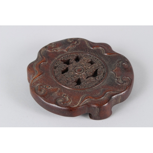 4 - A FINE CHINESE YIXING TEAPOT with hardwood stand.  12cms high.