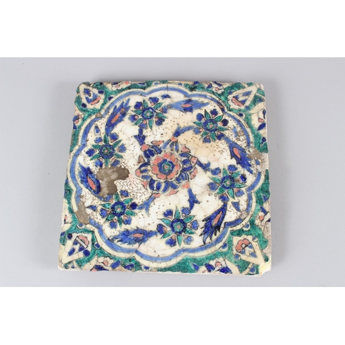 45 - A 19TH CENTURY QAJAR POTTERY TILE, with floral decoration.  27.5cms wide.