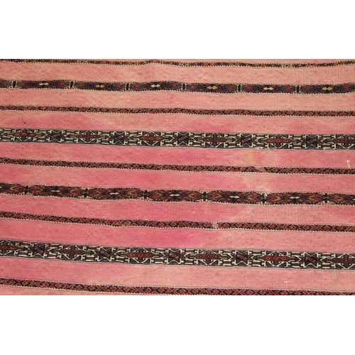 51 - A PERSIAN SADDLE BAG, LATE 19TH CENTURY, pink ground, with striped decoration.  152cms x 84cms.