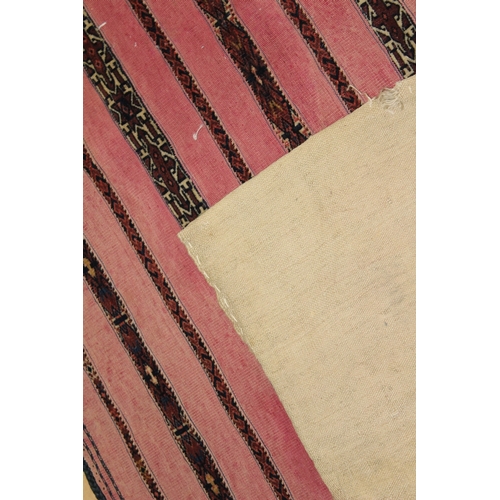 51 - A PERSIAN SADDLE BAG, LATE 19TH CENTURY, pink ground, with striped decoration.  152cms x 84cms.