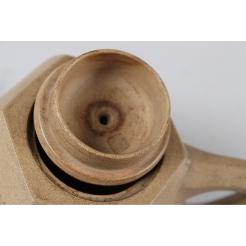 57 - A CHINESE YIXING POTTERY TEAPOT, of hexagonal form, incised with calligraphy.  15cms wide.