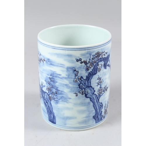 58 - A CHINESE BLUE AND WHITE BRUSH POT, painted with birds amongst prunus trees.  15cms high.