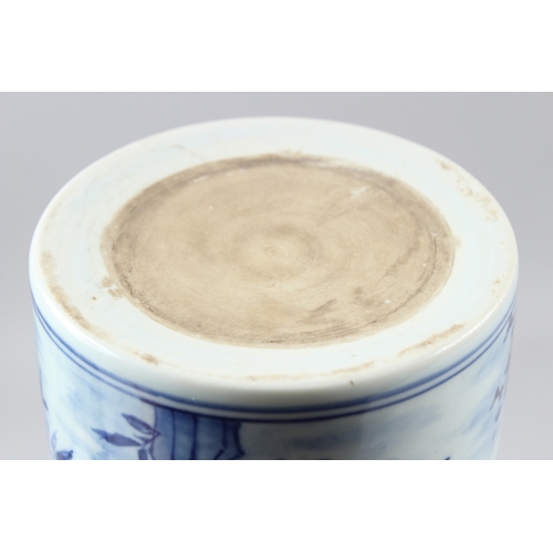 58 - A CHINESE BLUE AND WHITE BRUSH POT, painted with birds amongst prunus trees.  15cms high.