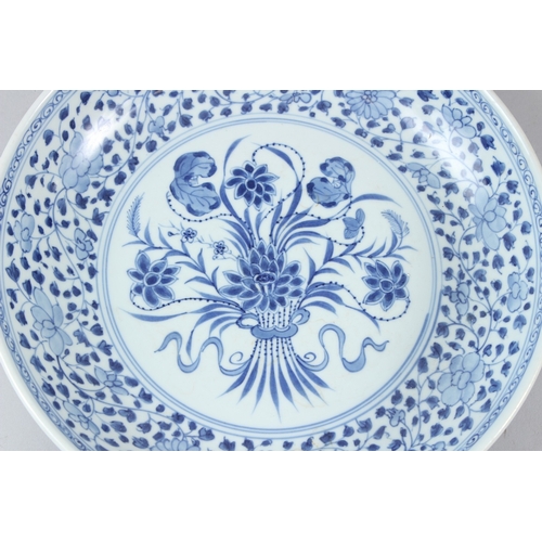 60 - A CHINESE BLUE AND WHITE CIRCULAR DISH, painted to the centre with a floral spray within a floral de... 