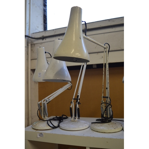 77 - Three angle poise lamps.