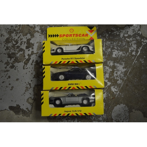 93 - Three boxed model cars.