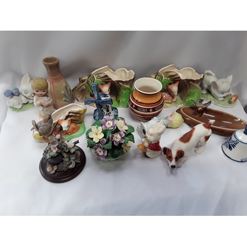 1059 - A collection of various ornaments to include animals, a Toby jug and Fauna china.