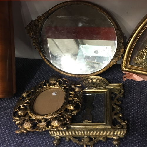 1026 - A gilt framed mirror with two picture frames.