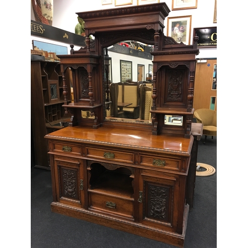 562 - A large Edwardian oak carved dresser with mirrored back.