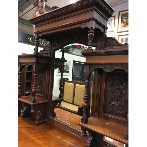 562 - A large Edwardian oak carved dresser with mirrored back.